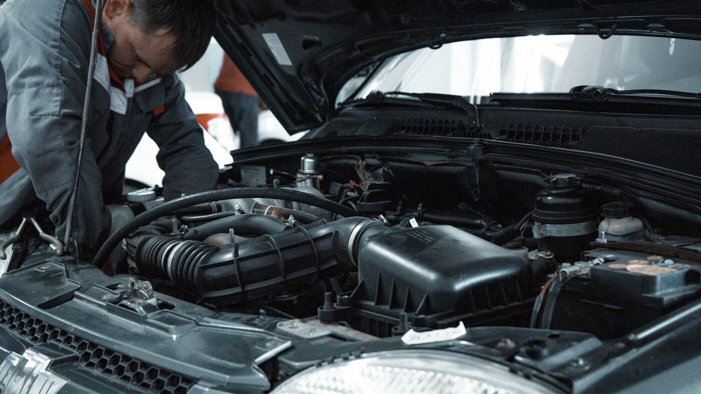 A Core Autobody technician working under the hood in the East Vancouver shop